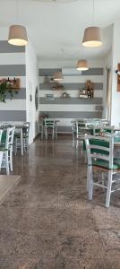 a dining room with tables and chairs and lights at La casina di Ale in Marina di Carrara