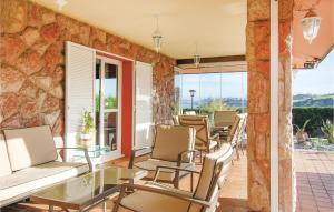 a patio with chairs and a glass table at 3 Bedroom Awesome Home In Antromero in Candás