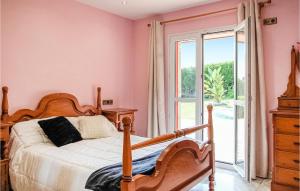 a bedroom with pink walls and a bed and a window at 3 Bedroom Awesome Home In Antromero in Candás