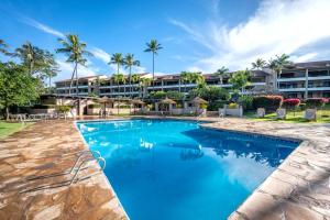 a swimming pool in front of a resort at K B M Resorts KRO-Q301 2Bedroom Ocean Views with Free Rental Car in Kaanapali