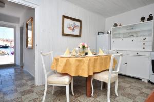 a dining room with a table and chairs and a kitchen at Holiday home Gariful in Milna +65 photos