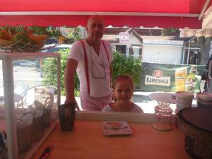 a man standing next to a girl in front of a counter at Mechta Family Hotel in Obzor