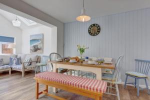 a living room with a table and chairs and a dining room at Egret 4 in South Creake