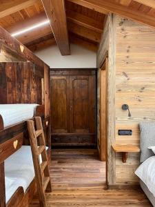 a bedroom with two bunk beds in a log cabin at La Louye su La Goumba in Pontboset