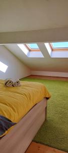 a bedroom with a bed with skylights in the ceiling at Apartment Niko in Vir