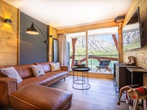 a living room with a couch and a large window at Appartement Tignes, 3 pièces, 5 personnes - FR-1-480-84 in Tignes