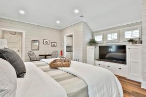a bedroom with a bed and a flat screen tv at The Cottages at Laurel Brooke in Peachtree City