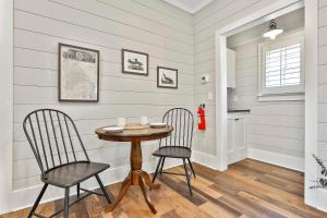 a dining room with a table and two chairs at The Cottages at Laurel Brooke in Peachtree City