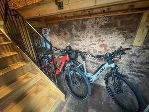 two bikes are parked next to a wall at Chipley Escapes - Otters Holt in Milverton