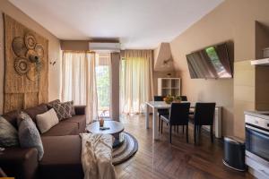 a living room with a couch and a table at Quiet & Modern Maisonette in Varna City
