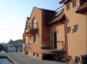 a building with balconies on the side of it at Korona Home in Sárvár