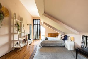 a attic bedroom with a bed and a ladder at Quiet & Modern Maisonette in Varna City