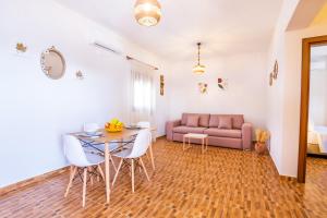 a living room with a table and a couch at Enalia Suites in Amoopi