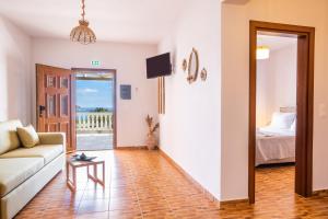 a living room with a couch and a bed at Enalia Suites in Amoopi