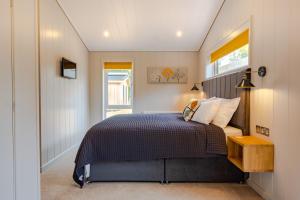 Schlafzimmer mit einem Bett und einem Fenster in der Unterkunft Ingol Lodge 2 in Ingoldisthorpe