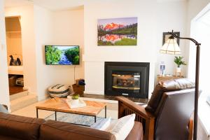 a living room with a couch and a fireplace at Mt Baker Den, Sleeps 4 in Glacier