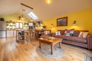 a living room with a couch and a table at Bootlegger's Barn in Heacham