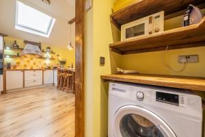 a laundry room with a washer and dryer at Bootlegger's Barn in Heacham