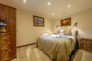 a bedroom with a bed with two towels on it at Bootlegger's Barn in Heacham