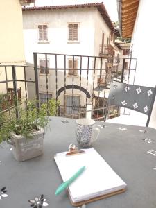 a table with a cup of coffee on a balcony at appartamenti Residenza 1928 in Tremosine Sul Garda