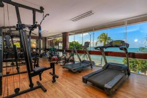 a gym with cardio equipment in a room with the ocean at D Beach Resort in Natal
