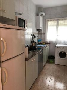 a kitchen with a refrigerator and a washing machine at Ayuntamiento Alicante in Alicante