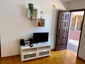 a living room with a tv on a white cabinet at Apartamento La Playa , Los Cancajos La Palma in Los Cancajos