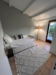 a bedroom with a bed and a window and a rug at La Brise Marine in Cogolin