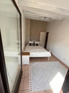 a small bedroom with a bed and a mirror at La Brise Marine in Cogolin
