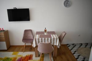 une salle à manger avec une table et des chaises et une télévision dans l'établissement Studio Rio, à Trebinje