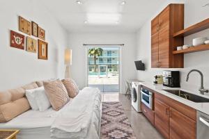 a living room with a couch and a kitchen at Funky Pool Side Cabana in DTPHX in Phoenix