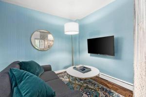 a living room with a couch and a tv at Studio in the Heart of Seattle - Fast Wi-Fi & AC in Seattle