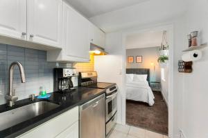 a kitchen with a sink and a kitchen with a bed at Studio in the Heart of Seattle - Fast Wi-Fi & AC in Seattle