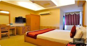 Cama ou camas em um quarto em Collection O Hotel Shree Ji