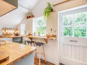 a kitchen with a counter and a window at Jackdaw Cottage in Knighton