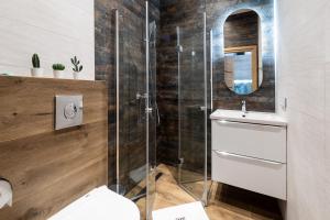 a bathroom with a shower and a toilet and a sink at Pokoje, Noclegi, Apartamenty Dune Resort Łeba in Łeba