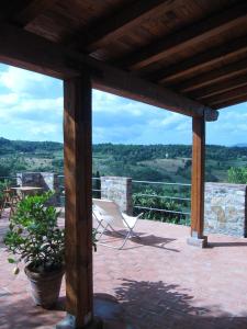 un patio con una silla, una mesa y vistas en Agriturismo Fattoio alle Ripe - Frantoio, en SantʼEllero