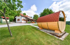 a small wooden house in a yard next to a house at Nice Home In Glina With Sauna in Donje Taborište +52 photos
