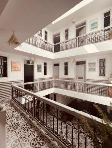 a large building with white walls and a staircase at Riad Allal in Marrakesh