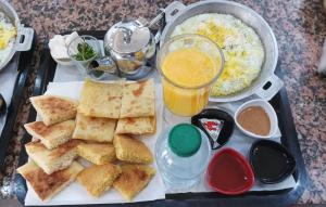 a tray of food with bread and rice and a drink at Marina Dreams in Dakhla