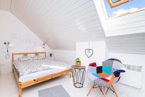 a bedroom with a bed and a chair at DOMEK LUKSUSOWY KASZUBSKA OSTOJA in Barkocin