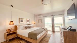 a bedroom with a bed and a large window at Ocean Villa Inn in San Diego