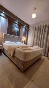 a bedroom with a large bed in a room at Modern Apartment Kallithea 2 in Kallithea Halkidikis