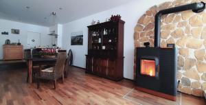 a living room with a fireplace and a dining table at Ferienwohnung Aroma Moselblick in Burgen
