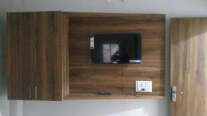 a cabinet with a television in it on a wall at OYO Flagship Hotel The Cloud in Jāmul