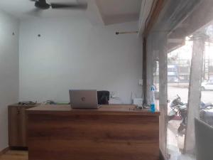 a room with a desk with a laptop on it at OYO Flagship Hotel The Cloud in Jāmul