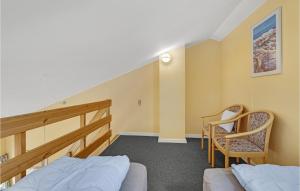 a bedroom with two beds and a stair case at Fan Bad, Lejl, 59 in Fanø