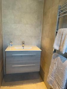 a bathroom with a sink and a mirror at Beautiful Executive Home in Llanelli