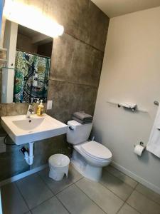 a bathroom with a white toilet and a sink at Modern Capitol Hill Studio Steps to Volunteer Park in Seattle