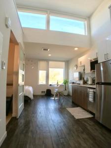 a large room with a kitchen with a large window at Modern Capitol Hill Studio Steps to Volunteer Park in Seattle